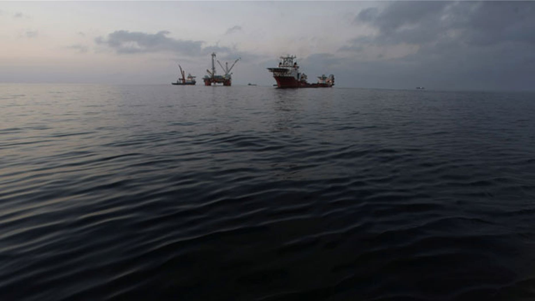 May 7: The Q4000, center, which has lowered the oil containment vessel to the sea floor, is seen at sunset from the offshore supply vessel Joe Griffin, at the site of the Deepwater Horizon oil spill containment efforts in the Gulf of Mexico off the coast of Lousiana.