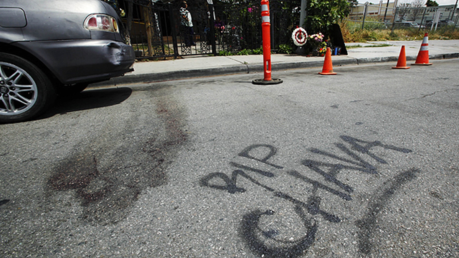 May 8: Blood stains the pavement, along with a painted 'RIP Chava' memorial and one on the sidewalk, in the street at the scene where a man shot and killed his girlfriend and two 5-year-old twins, before turning the gun on himself in a murder-suicide inside an SUV that was witnessed by three other children.