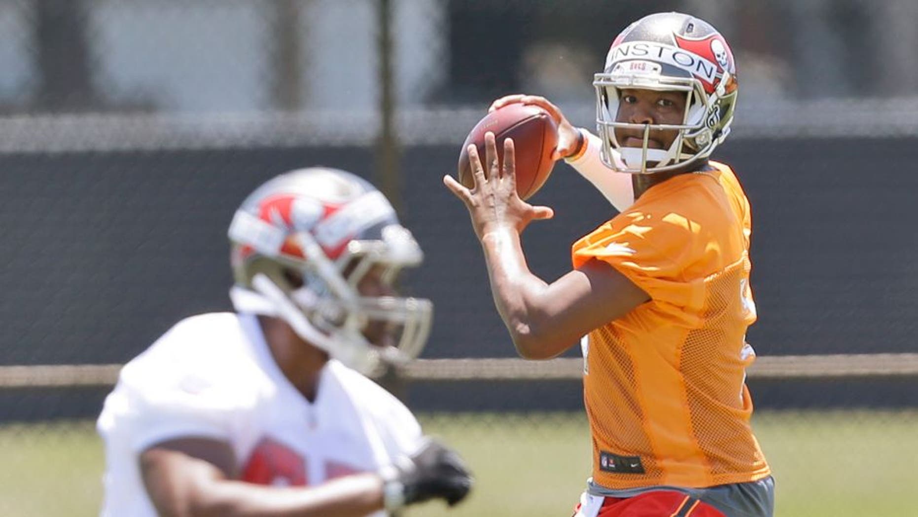 Tampa Bay Buccaneers quarterback Jameis Winston, rear, prepares to pass to tight end Emmanuel Ogbuehi as they run through drills during an NFL rookie minicamp in Tampa, Fla., Friday, May 8, 2015. (AP Photo/Wilfredo Lee)