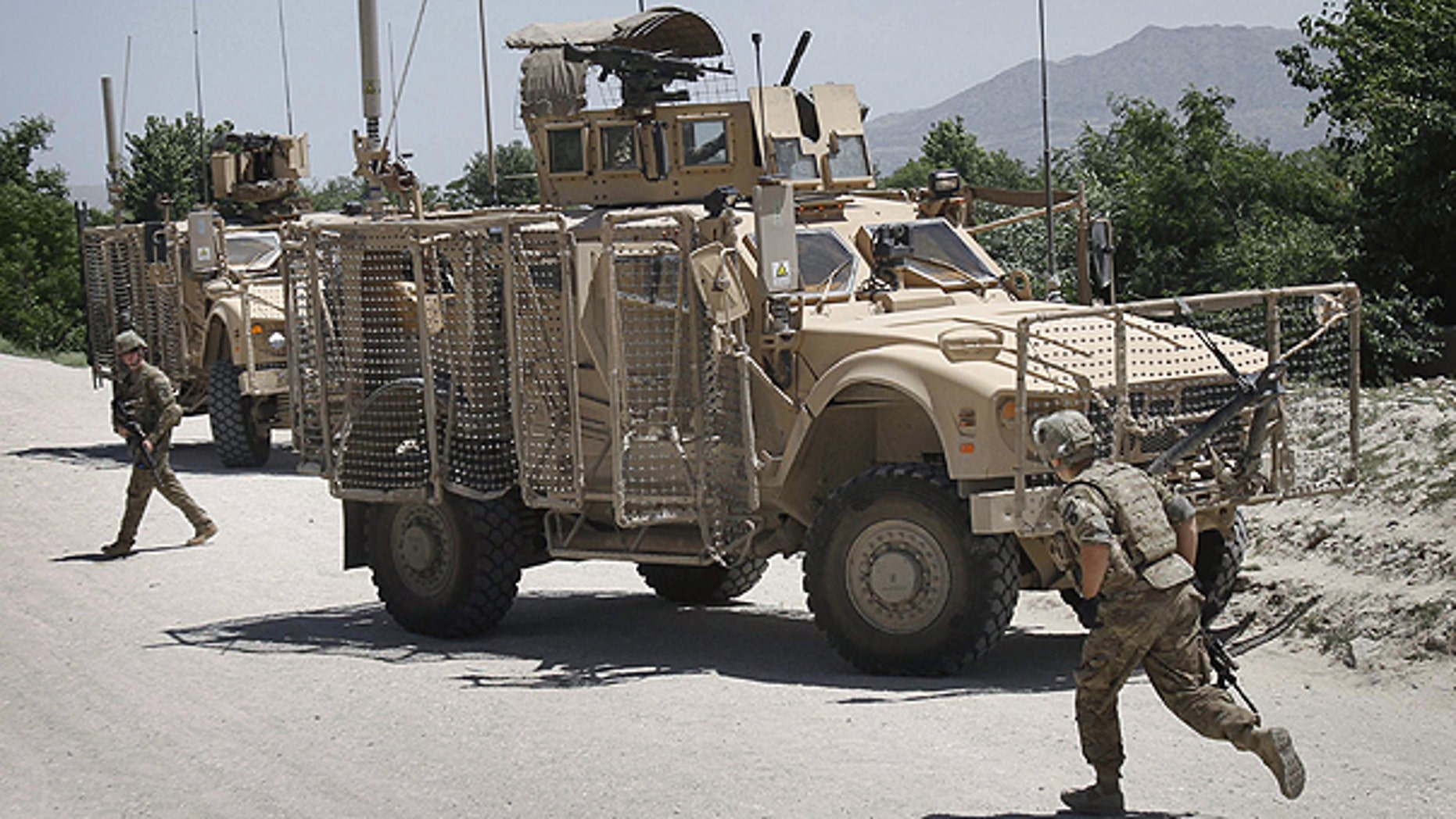 May 9: U.S. soldiers with the NATO led International Security Assistance Force (ISAF) react after their convoy was attacked by a suicide attacker using a motorcycle in Qarghayi, Laghman province east of Kabul, Afghanistan.