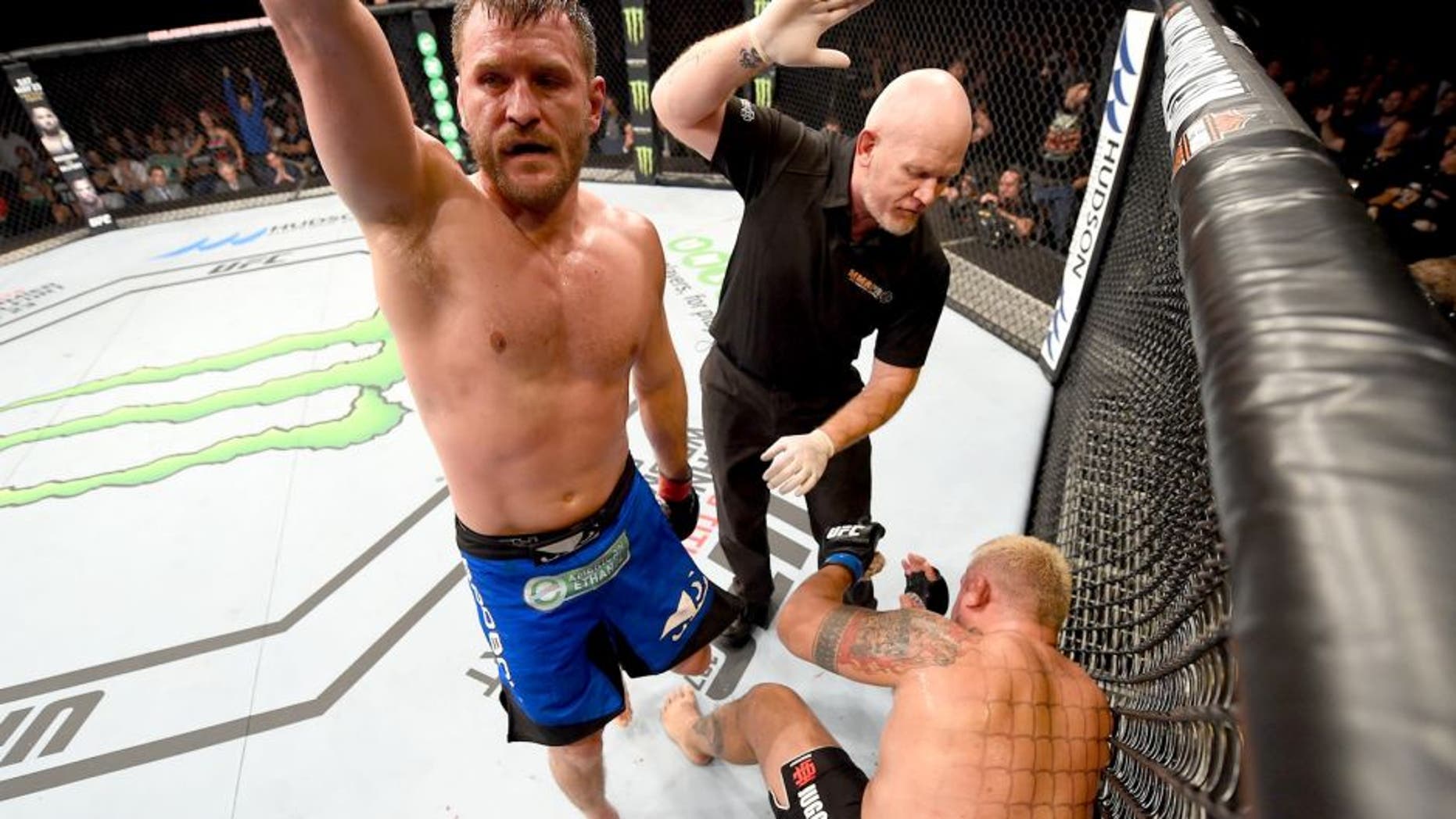 ADELAIDE, AUSTRALIA - MAY 10: (L-R) Stipe Miocic celebrates his TKO victory over Mark Hunt in their heavyweight bout during the UFC Fight Night event at the Adelaide Entertainment Centre on May 10, 2015 in Adelaide, Australia. (Photo by Josh Hedges/Zuffa LLC/Zuffa LLC via Getty Images)