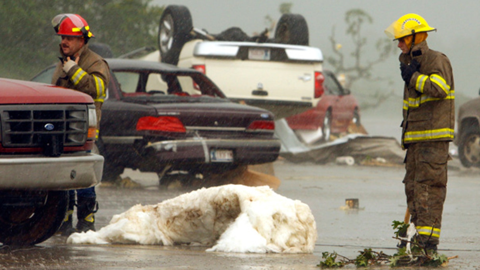 May 10: Overturned cars and debris litter the street after a violent storm tore through Norman, Okla.