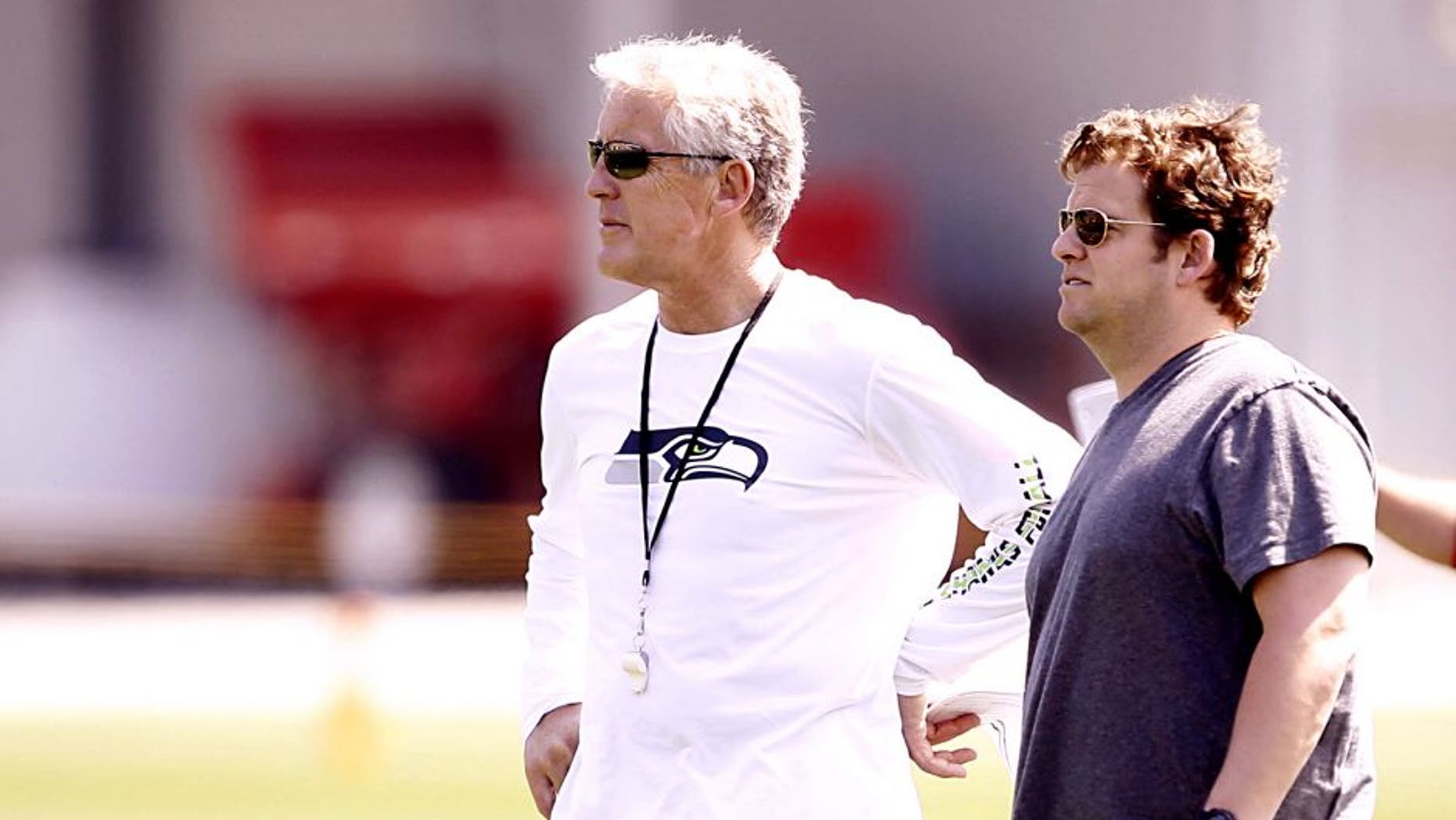 May 10, 2013; Renton, WA, USA; Seattle Seahawks head coach Pete Carroll, left, and general manager John Schneider observe a rookie minicamp practice at the Virginia Mason Athletic Center. Mandatory Credit: Joe Nicholson-USA TODAY Sports