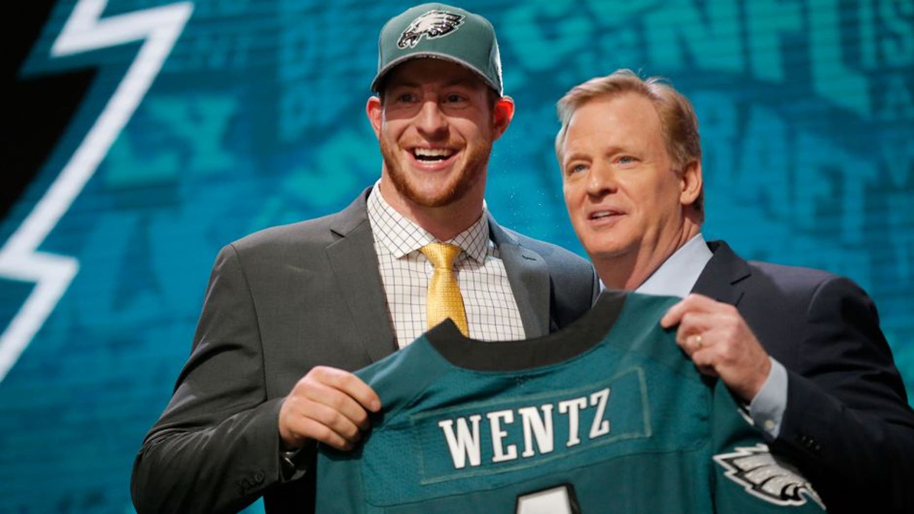 CHICAGO, IL - APRIL 28: (L-R) Carson Wentz of the North Dakota State Bison holds up a jersey with NFL Commissioner Roger Goodell after being picked #2 overall by the Philadelphia Eagles during the first round of the 2016 NFL Draft at the Auditorium Theatre of Roosevelt University on April 28, 2016 in Chicago, Illinois. (Photo by Jon Durr/Getty Images)