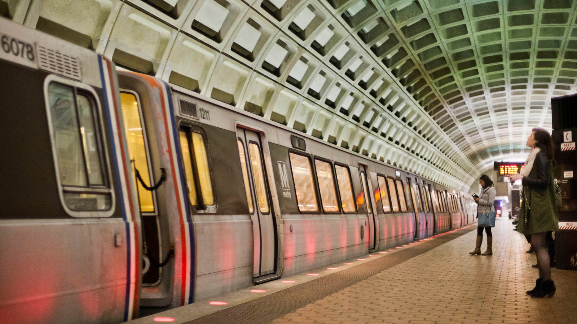 In this photo taken March 12, 2015, passengers wait on the platform before boarding a train at the U Street Metro Station in Washington.