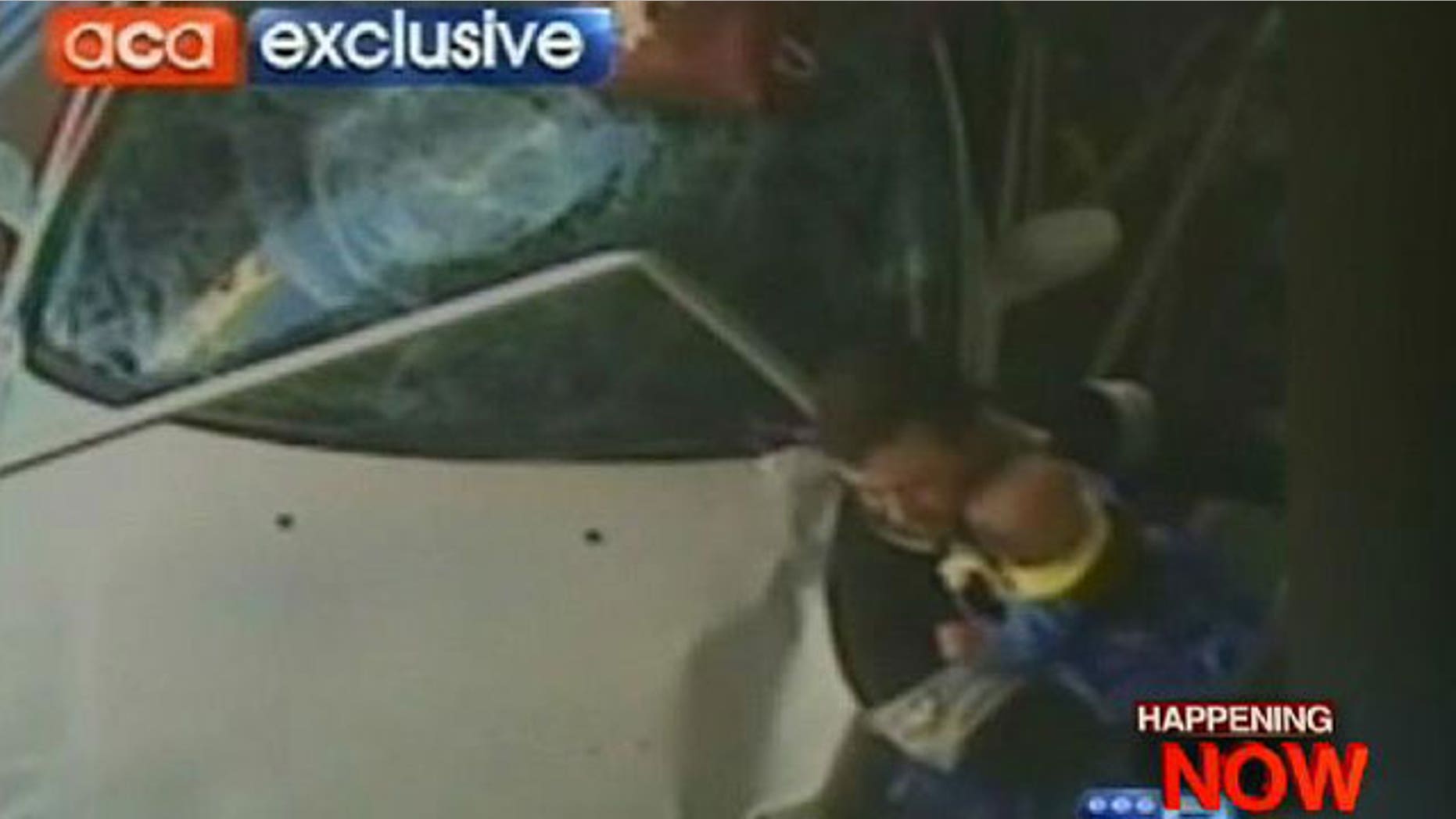 A car plows into Andrew Leitch as he holds his son Hayden on a sidewalk in a Sydney suburb.