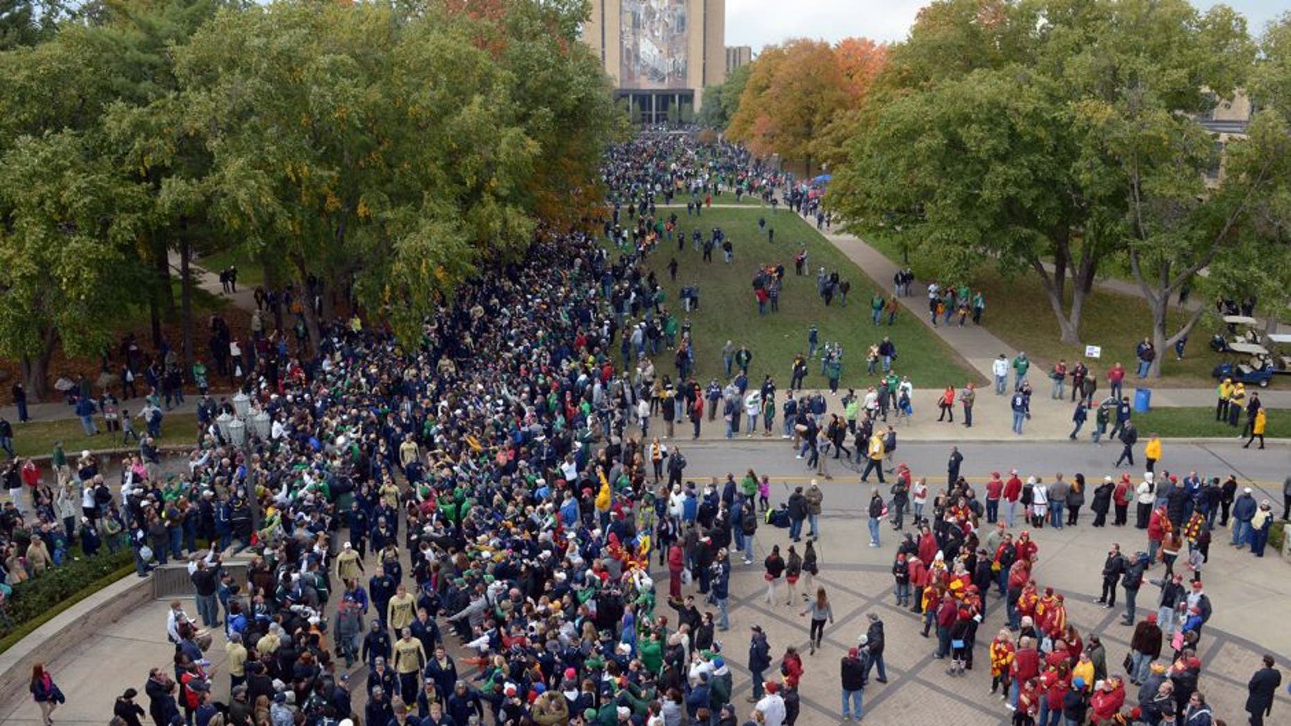 Oct 19, 2013; South Bend, IN, USA; Notre Dame Fighting Irish coach Brian Kelly leads players into Notre Dame Stadium with the Hesburgh Library Word of Life Mural aka Touchdown Jesus before the game against the Southern California Trojans. Mandatory Credit: Kirby Lee-USA TODAY Sports