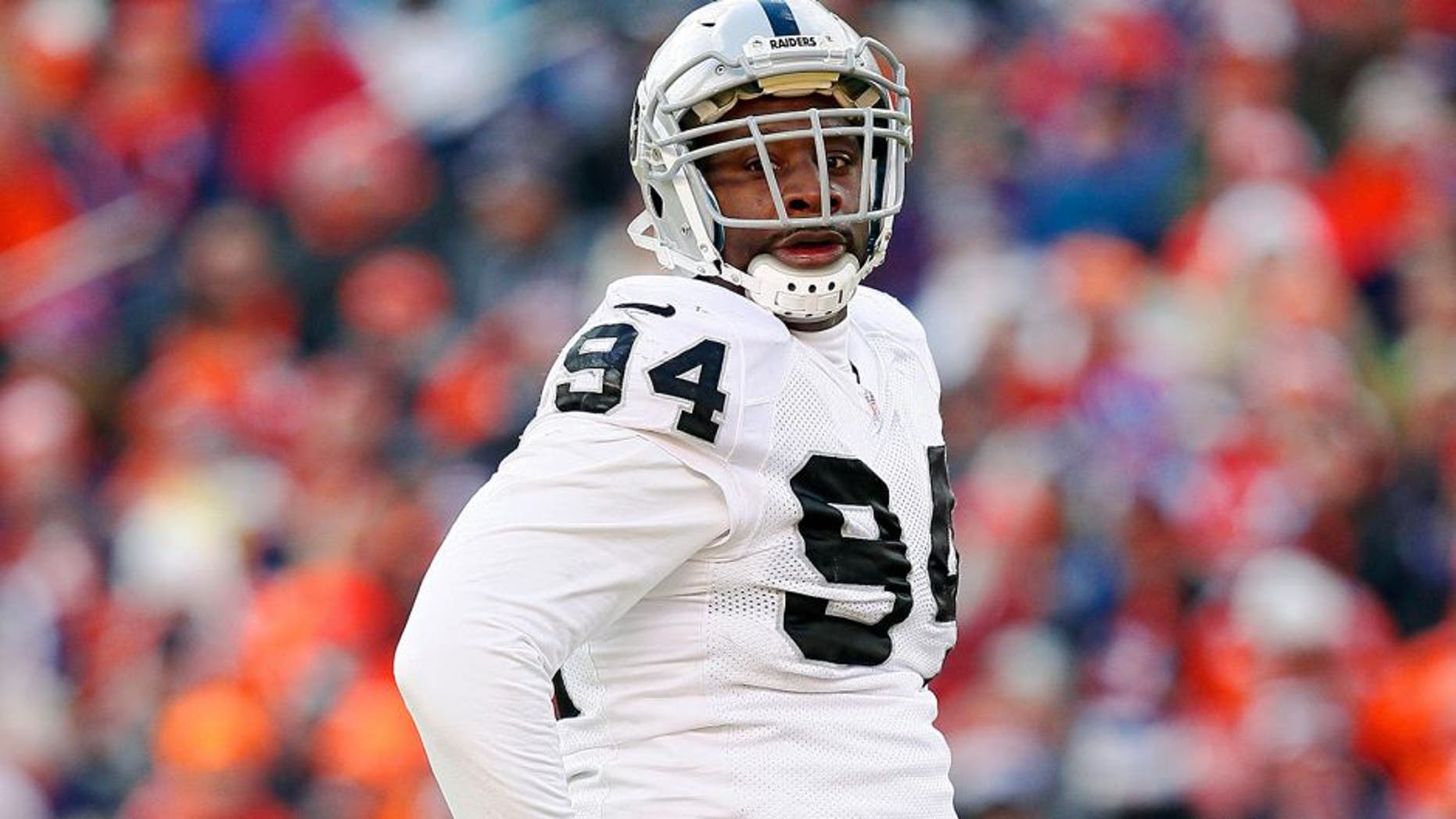 Dec 28, 2014; Denver, CO, USA; Oakland Raiders defensive tackle Antonio Smith (94) in the first quarter against the Denver Broncos at Sports Authority Field at Mile High. The Broncos defeated the Raiders 47-14. Mandatory Credit: Isaiah J. Downing-USA TODAY Sports