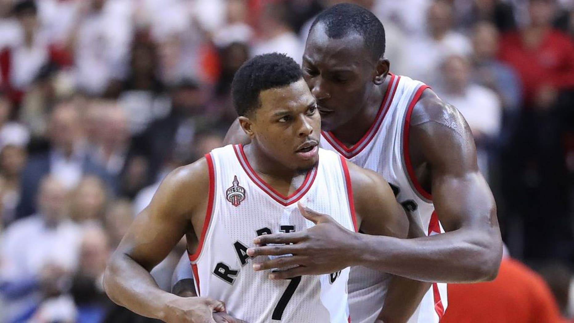 TORONTO, ON- MAY 11: Bismack Biyombo congratulates Kyle Lowry after he hit a key basket late in the game as the Toronto Raptors beat the Miami Heat in game five 99-91 of their Eastern Conference Semifinal at the Air Canada Centre in Toronto. May 11, 2016. (Steve Russell/Toronto Star via Getty Images)