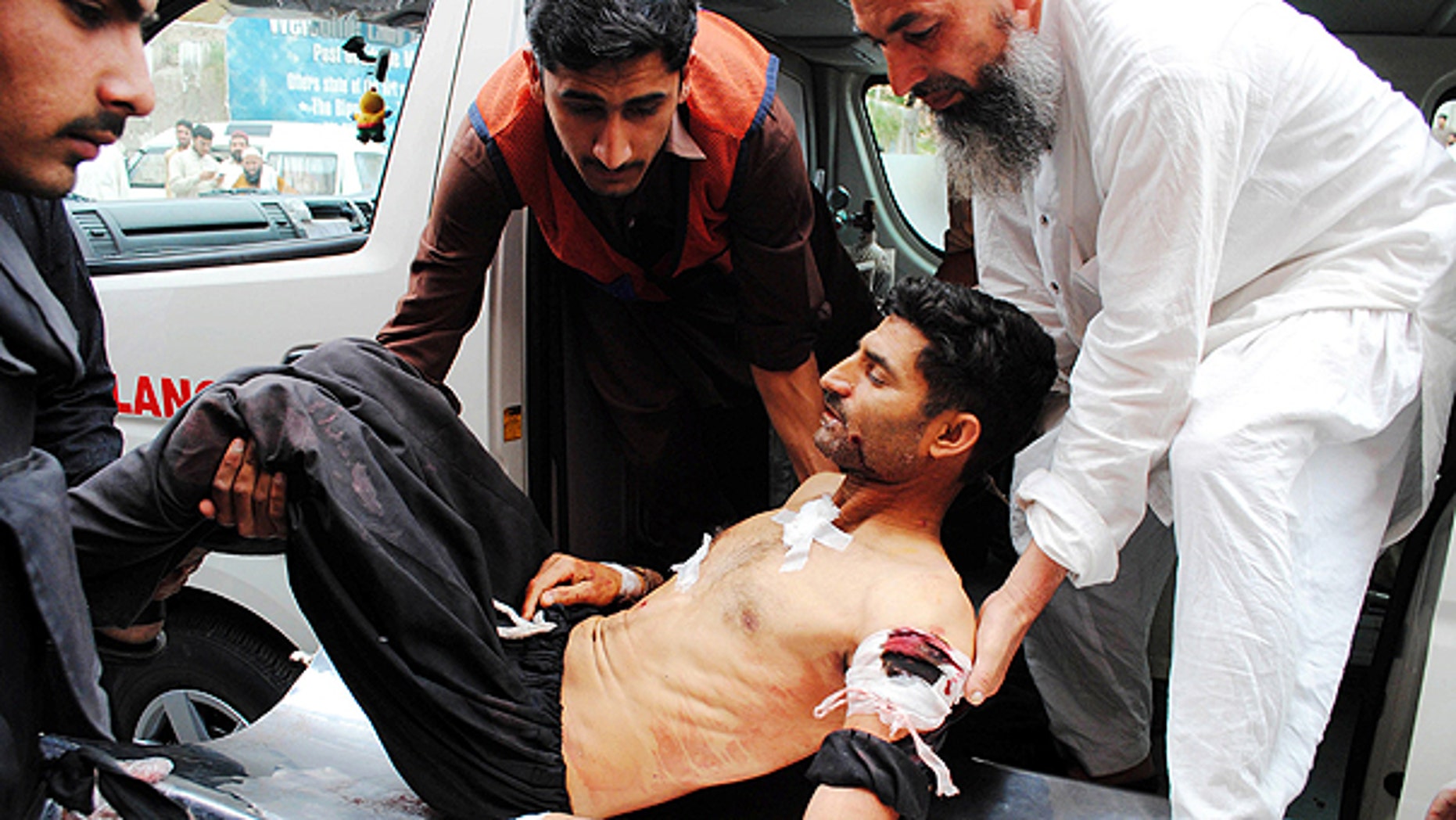 May 13: In this photo released by China's Xinhua News Agency, people transfer an injured man to a hospital in Peshawar, Pakistan.