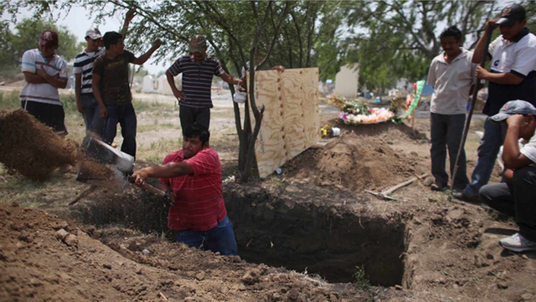 April 27: Family members of Alfredo Espinosa, allegedly killed by unknown assailants, dig a grave at a local cemetery in San Fernando, Mexico.