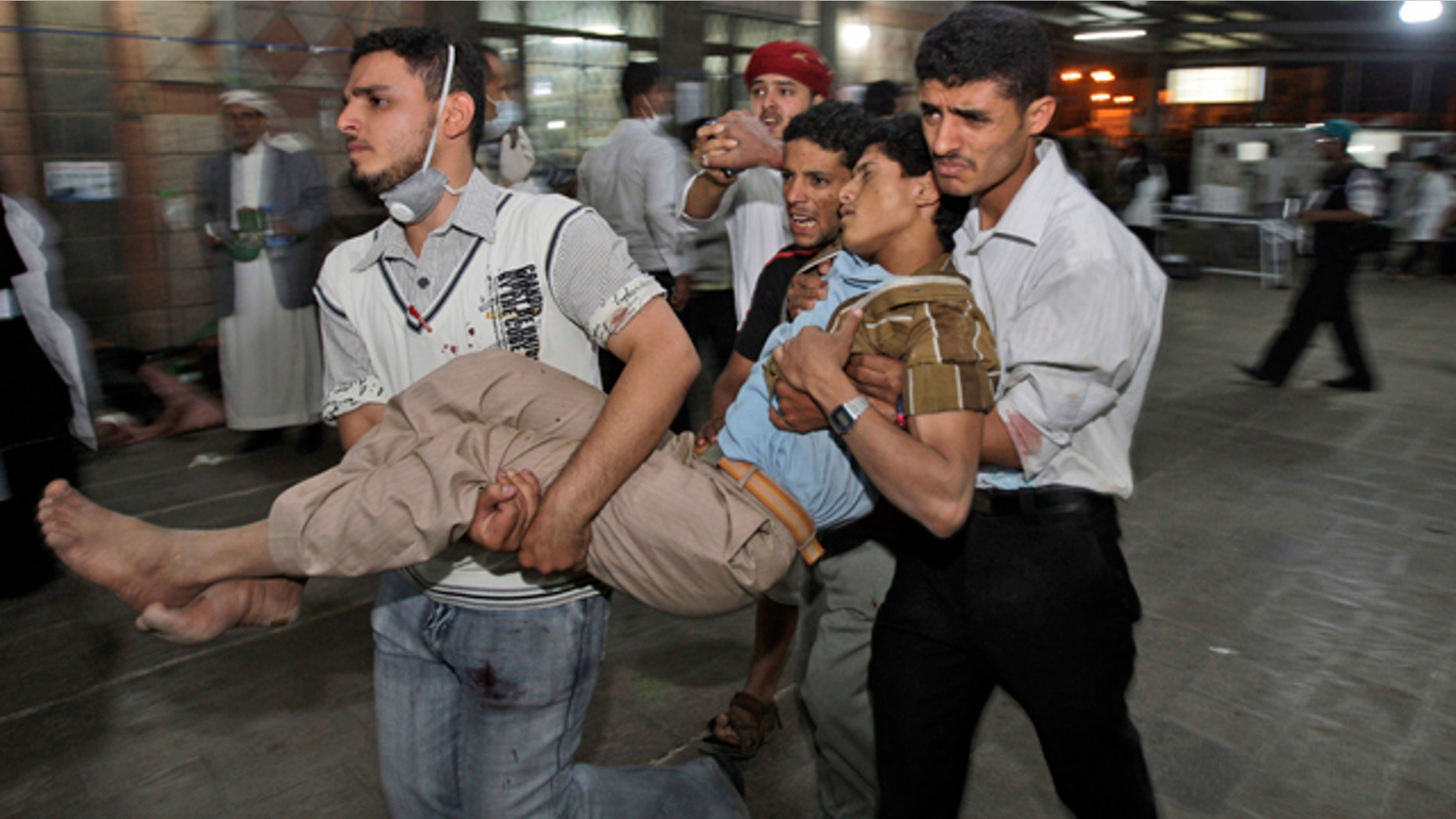 May 11: Anti-government protestors carry a wounded demonstrator to a field hospital during clashes with Yemeni security forces in Sanaa, Yemen.