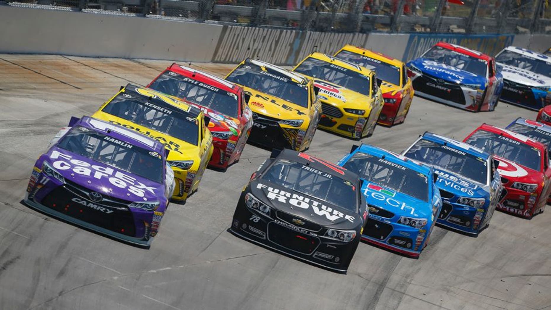 Denny Hamlin, driver of the #11 FedEx Cares Toyota, leads a pack of cars during the NASCAR Sprint Cup Series FedEx 400 Benefiting Autism Speaks at Dover International Speedway on May 31, 2015 in Dover, Delaware.