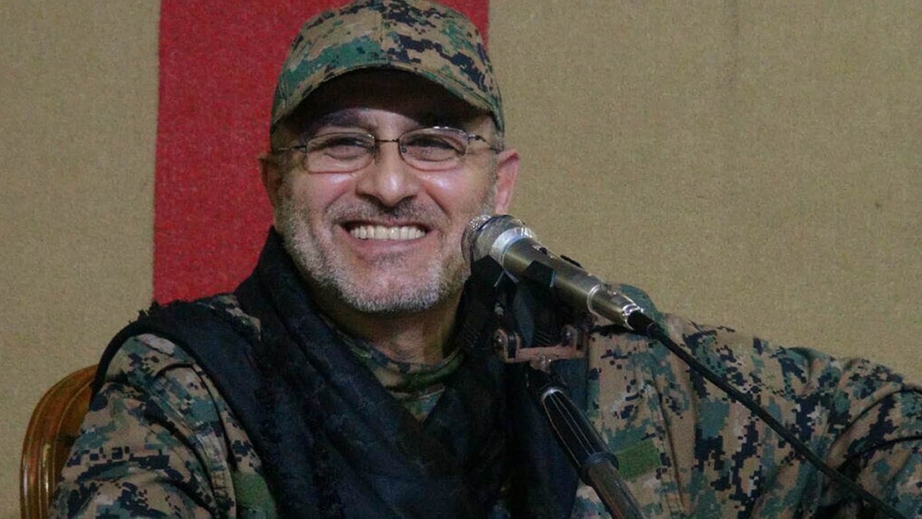 This undated handout image released on Friday, May 13, 2016, by Hezbollah Media Department, shows slain top military commander Mustafa Badreddine smiling during a meeting.