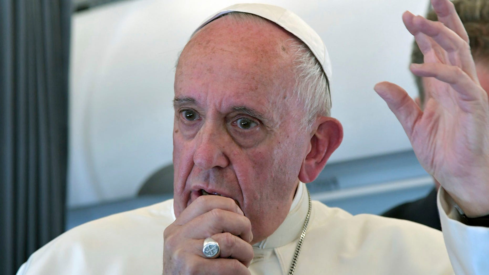 Pope Francis addresses journalists during the traditional press conference on his flight back to Rome, following a two-day visit at Fatima, Portugal, Saturday, May 13, 2017.