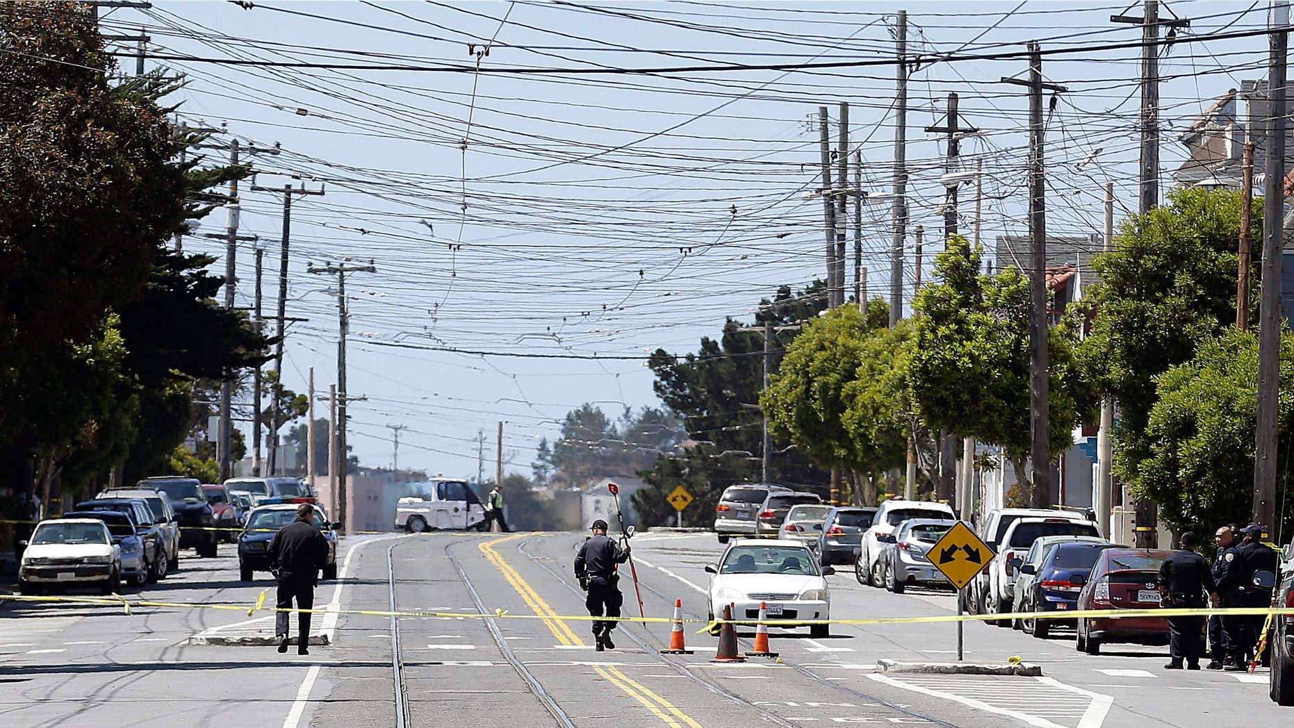May 12, 2015: San Francisco Police officers walk along San Jose Avenue where a boy was struck and killed by a light-rail train as he ran across a street in San Francisco.