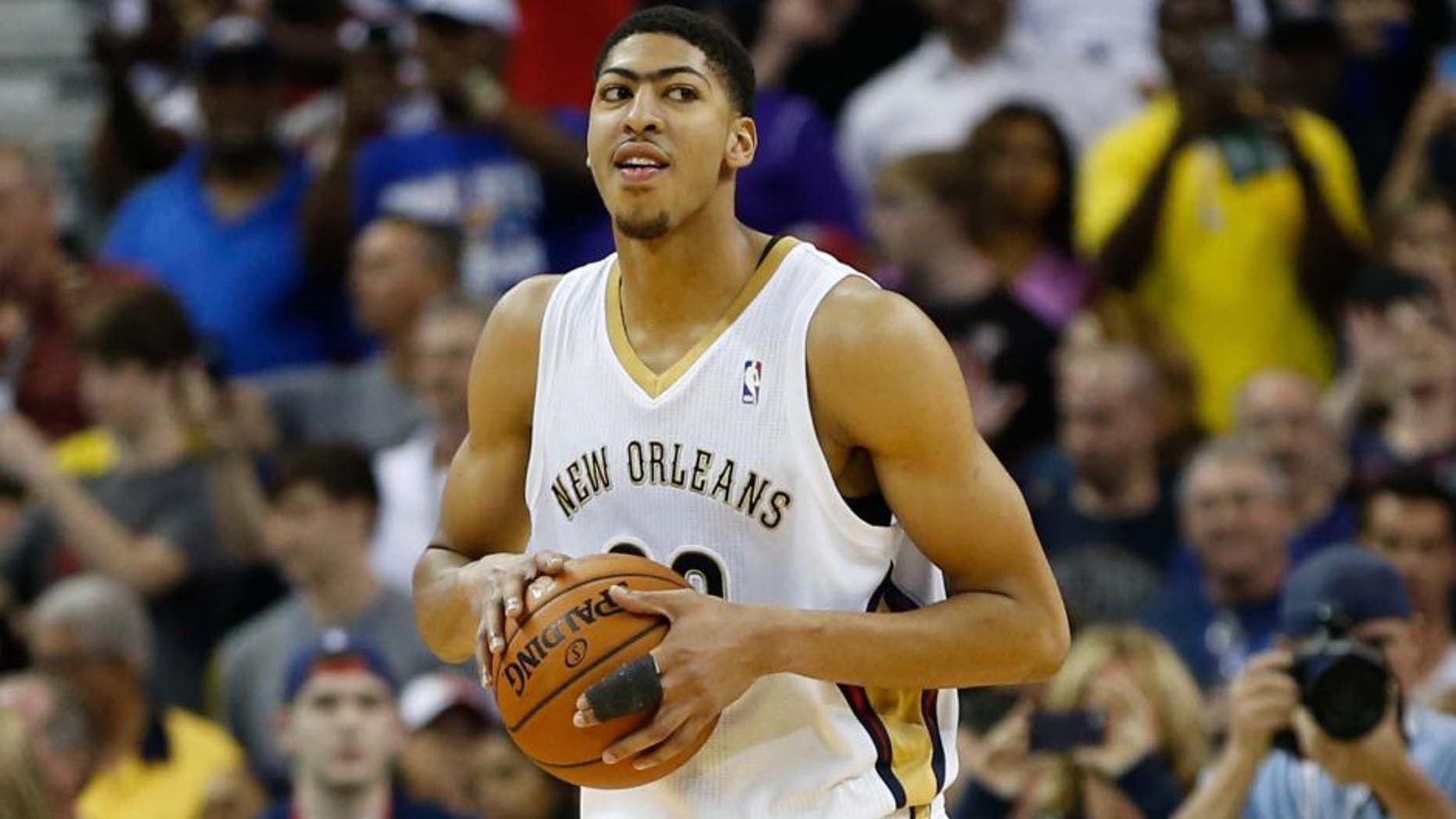 Mar 22, 2014; New Orleans, LA, USA; New Orleans Pelicans forward Anthony Davis (23) reacts as time expires during the fourth quarter of a win against the Miami Heat in a game at the Smoothie King Center. The Pelicans defeated the Heat 105-95. Mandatory Credit: Derick E. Hingle-USA TODAY Sports