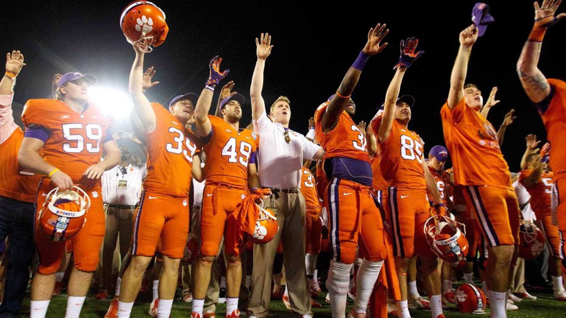 Dec 29, 2014; Orlando, FL, USA; Clemson Tigers players celebrate after the 2014 Russell Athletic Bowl at Florida Citrus Bowl. Clemson Tigers defeated the Oklahoma Sooners 40-6. Mandatory Credit: Joshua S. Kelly-USA TODAY Sports