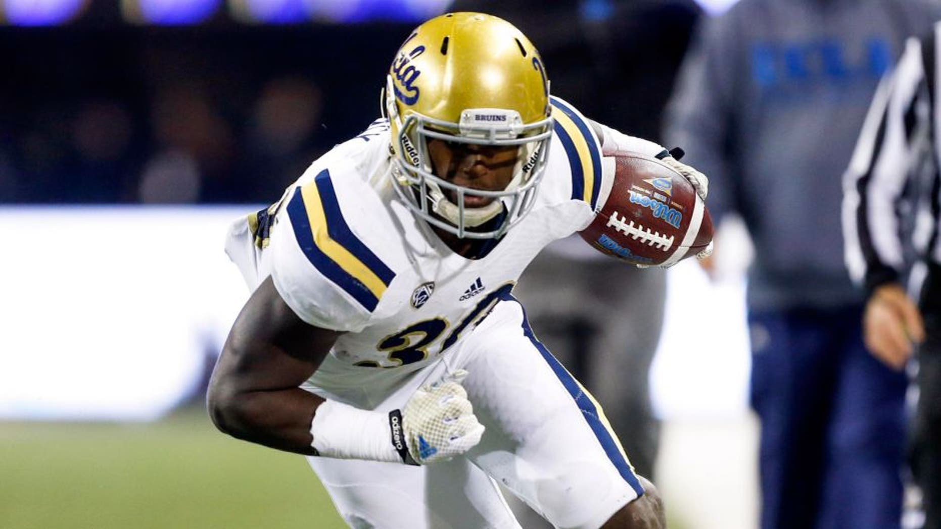 Nov 8, 2014; Seattle, WA, USA; UCLA Bruins running back Myles Jack (30) rushes for a 28-yard touchdown against the Washington Huskies during the second quarter at Husky Stadium. Mandatory Credit: Joe Nicholson-USA TODAY Sports