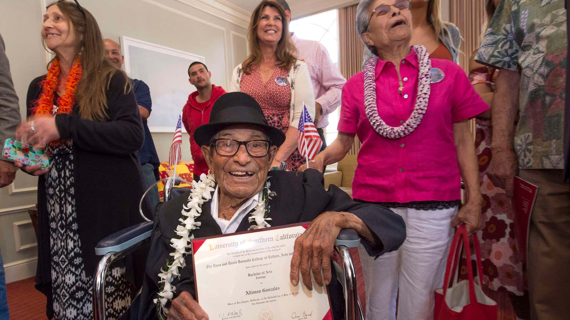 May 13, 2016: Alfonso Gonzales, 96, University of Southern California's oldest graduating Trojan receives his Bachelor of Science degree in zoology diploma from USC surrounded by family members, as part of the 2016 USC Commencement ceremony.