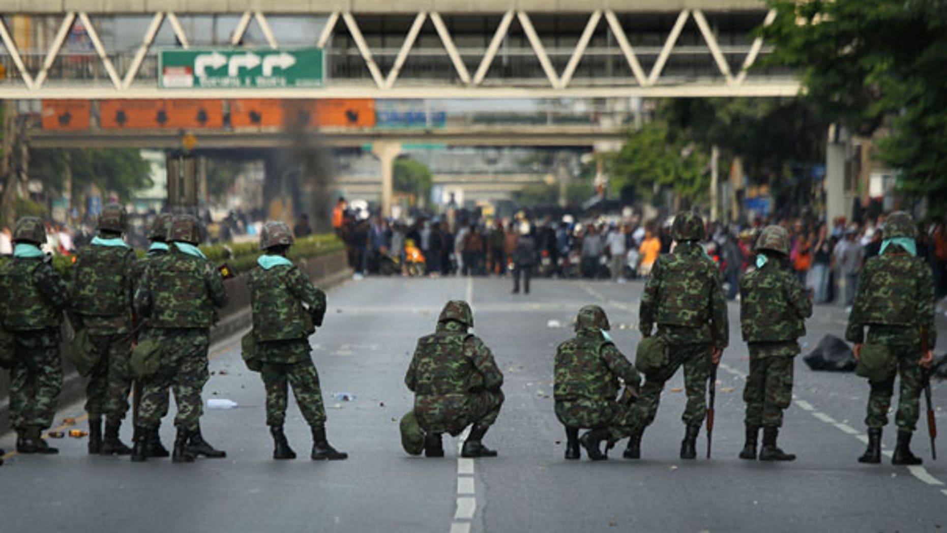 April 14: Thai soldiers stand off a crowd of anti-government protesters in Bangkok, Thailand, after initial government moves overnight to blockade them showed no results.