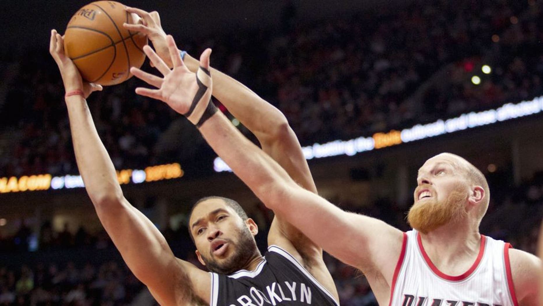 Nov 15, 2014; Portland, OR, USA; Brooklyn Nets center Jerome Jordan (9) and Portland Trail Blazers center Chris Kaman (35) go up for a rebound at Moda Center at the Rose Quarter. Mandatory Credit: Jaime Valdez-USA TODAY Sports