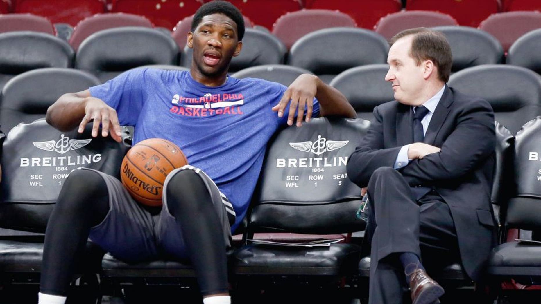 Dec 15, 2014; Philadelphia, PA, USA; Injured Philadelphia 76ers center Joel Embiid (left) talks with general manager and president Sam Hinkie (right) before a game against the Boston Celtics at Wells Fargo Center. Mandatory Credit: Bill Streicher-USA TODAY Sports