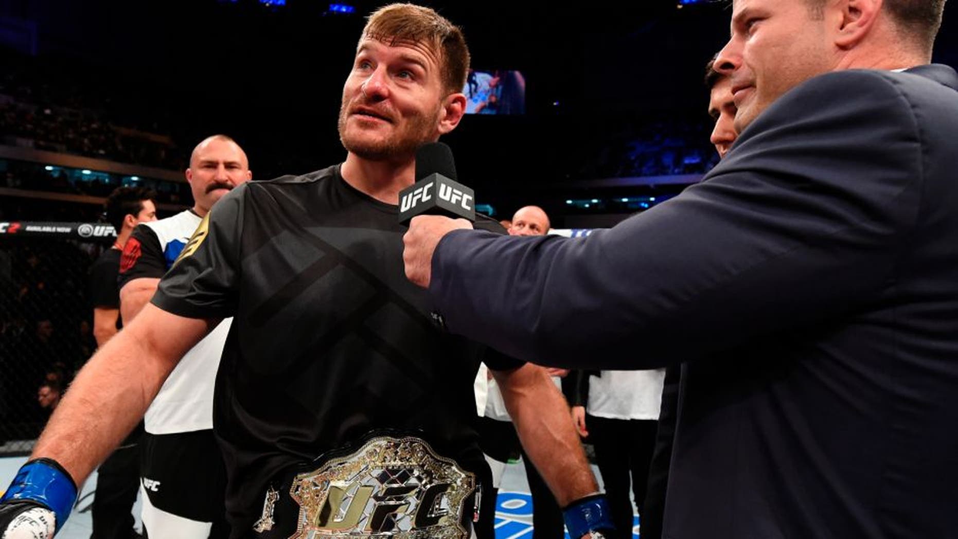 CURITIBA, BRAZIL - MAY 14: (L-R) Stipe Miocic is interviewed by UFC play-by-play broadcaster Brian Stann after defeating Fabricio Werdum of Brazil by KO in their UFC heavyweight championship bout during the UFC 198 event at Arena da Baixada stadium on May 14, 2016 in Curitiba, Parana, Brazil. (Photo by Josh Hedges/Zuffa LLC/Zuffa LLC via Getty Images)
