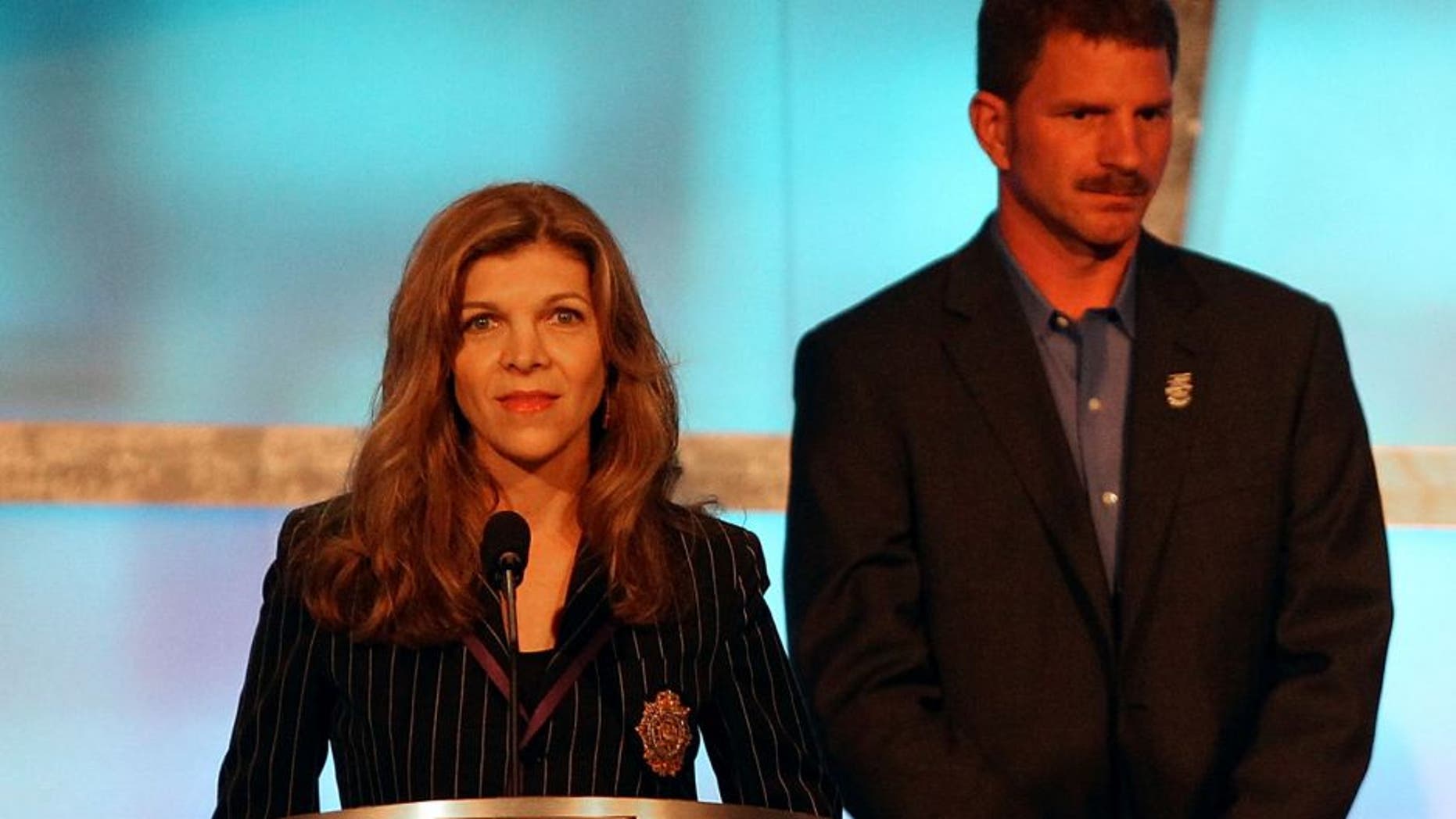 CHARLOTTE, NC - MAY 23: (L-R) Teresa Earnhardt speaks as Kerry Earnhardt, Kelley Earnhardt Elledge, Dale Earnhardt Jr. and Taylor Earnhardt stand on stage as Dale Earnhardt Sr. gets inducted into the 2010 NASCAR Hall of Fame Induction Ceremony at the Charlotte Convention Center on May 23, 2010 in Charlotte, North Carolina. (Photo by Streeter Lecka/Getty Images)