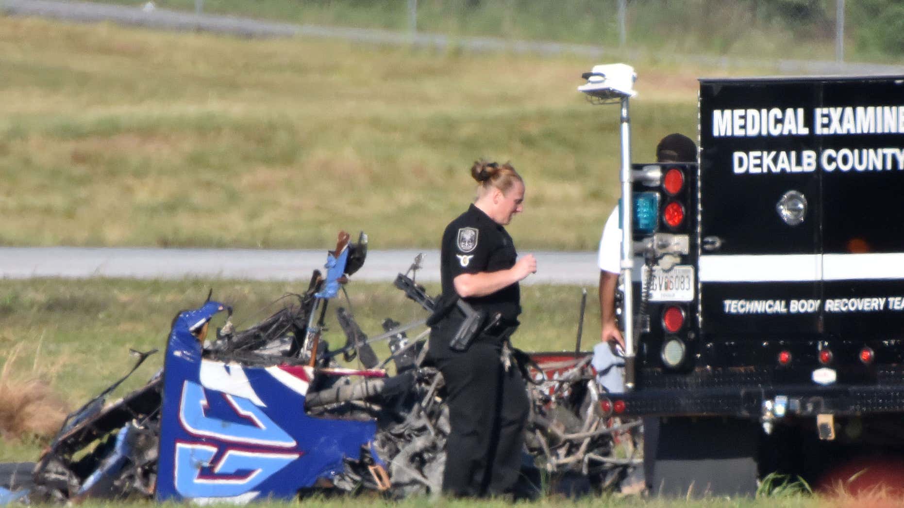 Authorities investigate the site of a small plane crash at DeKalb Peachtree Airport on Saturday, May 14, 2016, near the end of the Good Neighbor Day Air Show.