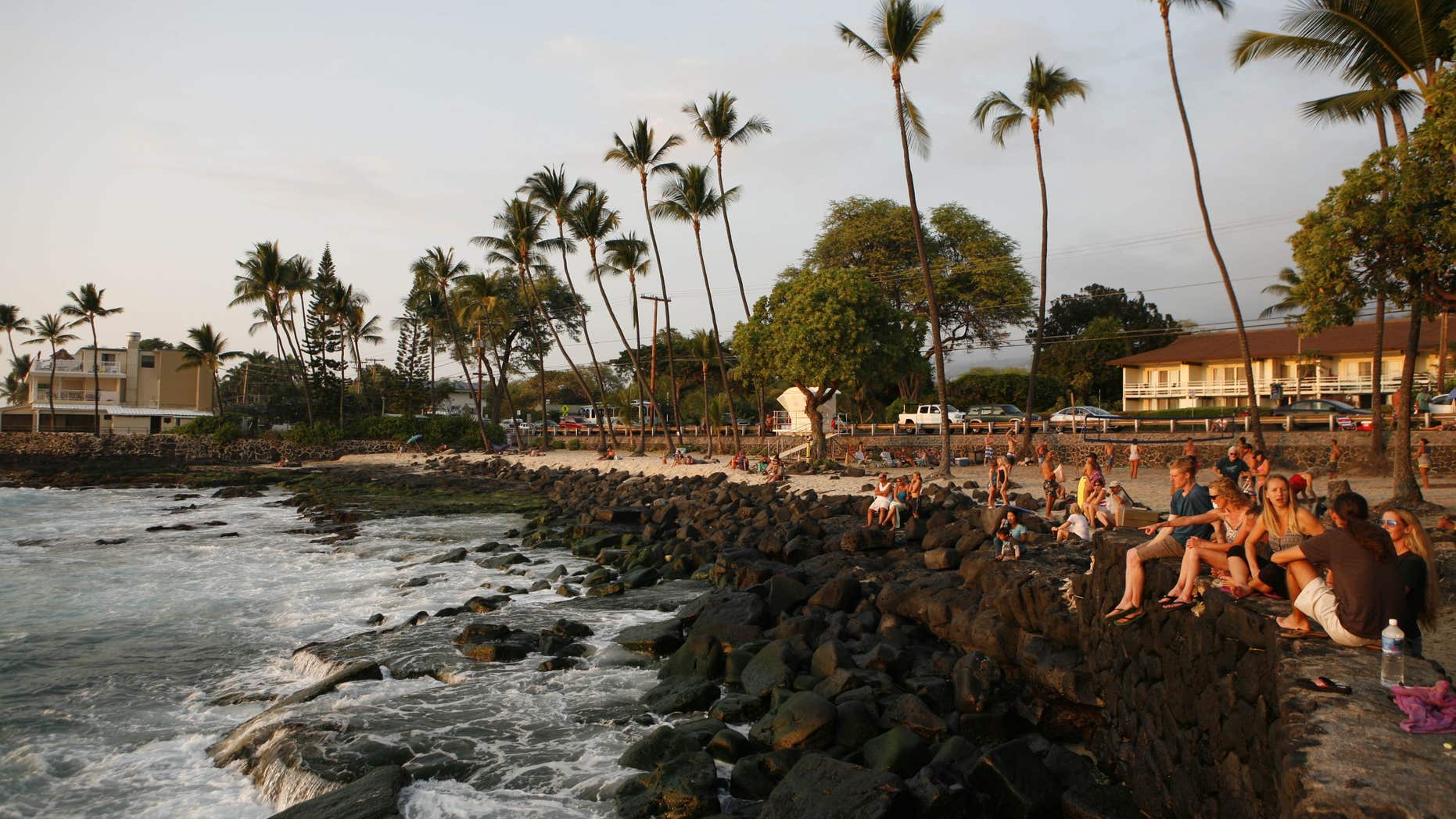 Feb. 9, 2016: Tourists and locals watch the sunset from White Sands Beach Park in Kailua-Kona, Hawaii.