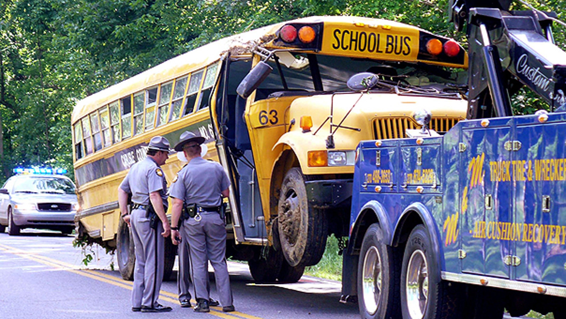 May 16: Kentucky State Police troopers gather around a Carlisle County school bus that crashed along U.S. 62 near the intersection of Ky. 307 in Carlisle County near the community of Cunningham, Ky.