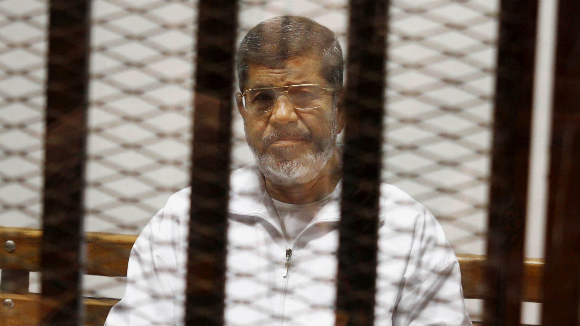 May 8, 2014: Egypt's ousted Islamist President Mohammed Morsi sits in a defendant cage in the Police Academy courthouse in Cairo, Egypt.