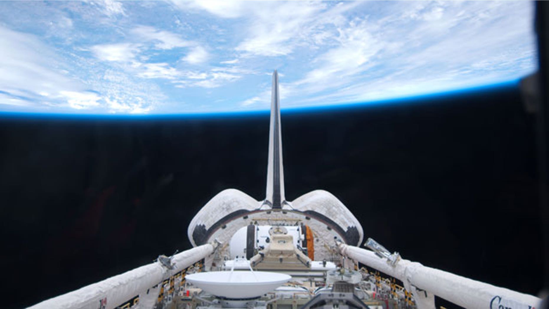 May 15: In this image provided by NASA, space shuttle Atlantis' cargo bay and its vertical stabilizer intersecting Earth's horizon was provided on by one of the six STS-132 crew members.