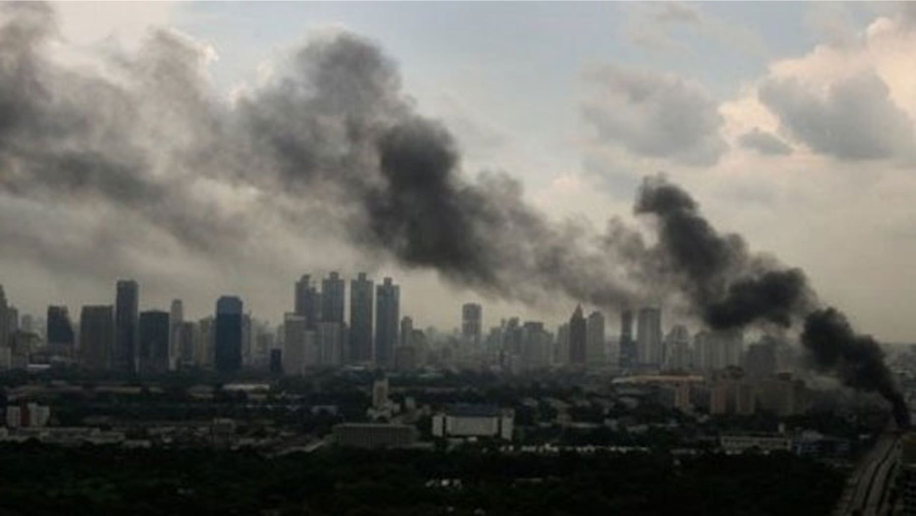 May 16: Heavy smoke appears as anti-government protesters burn tires at a main road in downtown Bangkok, Thailand.