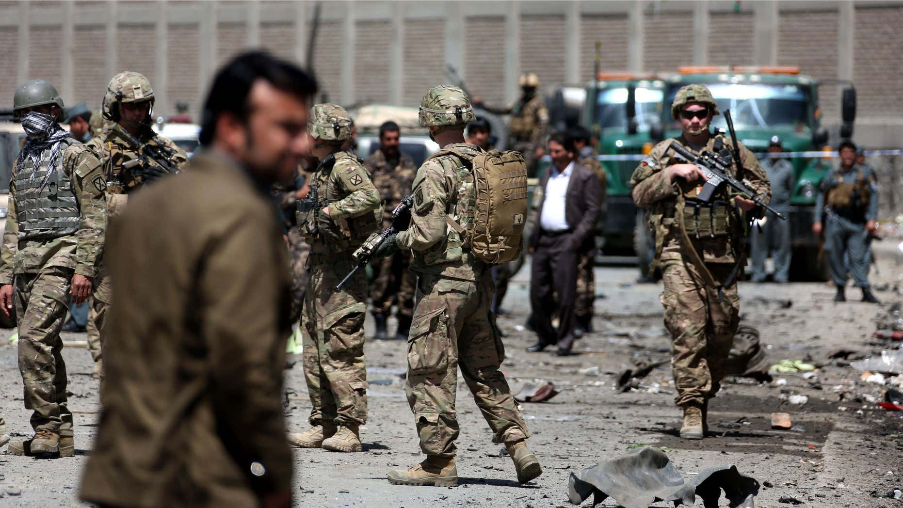 May 17, 2015: US forces and Afghan security inspect the site after a suicide bombing attack near Kabul's international airport in Kabul, Afghanistan.