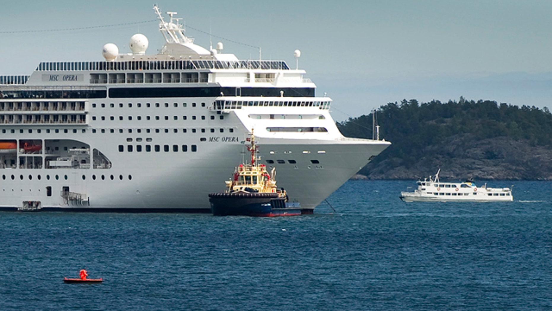 May 16: The cruise ship MSC Opera, left, carrying about 1,800 passengers, is towed into the Swedish port of Nynaeshamn.