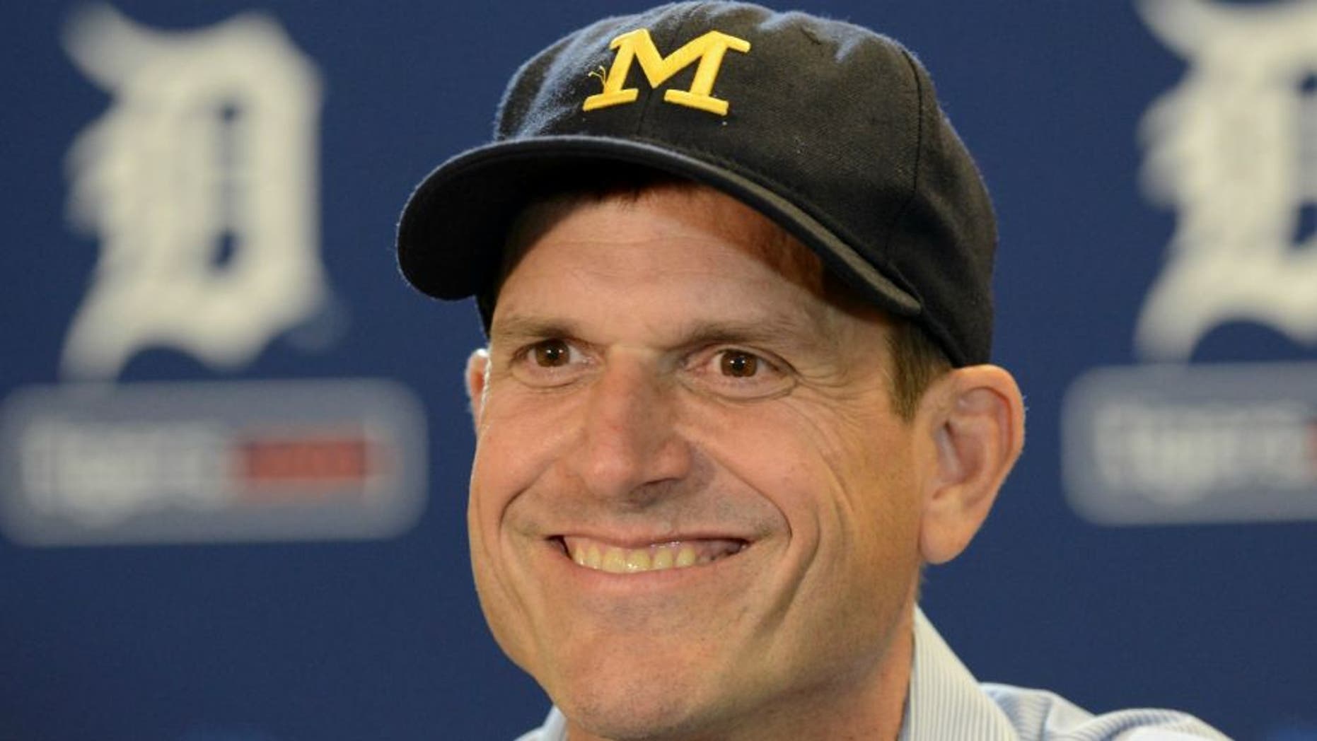 DETROIT, MI - JUNE 30: University of Michigan head football coach Jim Harbaugh looks on and smiles while talking to the media prior to the Major League Baseball game between the Pittsburgh Pirates and the Detroit Tigers at Comerica Park on June 30, 2015 in Detroit, Michigan. (Photo by Mark Cunningham/MLB Photos via Getty Images)