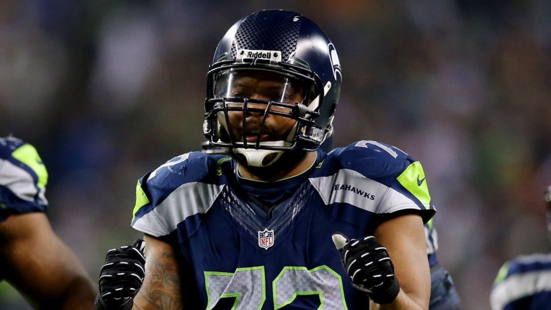 during the 2014 NFC Championship at CenturyLink Field on January 19, 2014 in Seattle, Washington.,SEATTLE, WA - JANUARY 19: Defensive end Michael Bennett #72 of the Seattle Seahawks and defensive tackle Clinton McDonald #69 react against the San Francisco 49ers during the 2014 NFC Championship at CenturyLink Field on January 19, 2014 in Seattle, Washington. (Photo by Ronald Martinez/Getty Images)