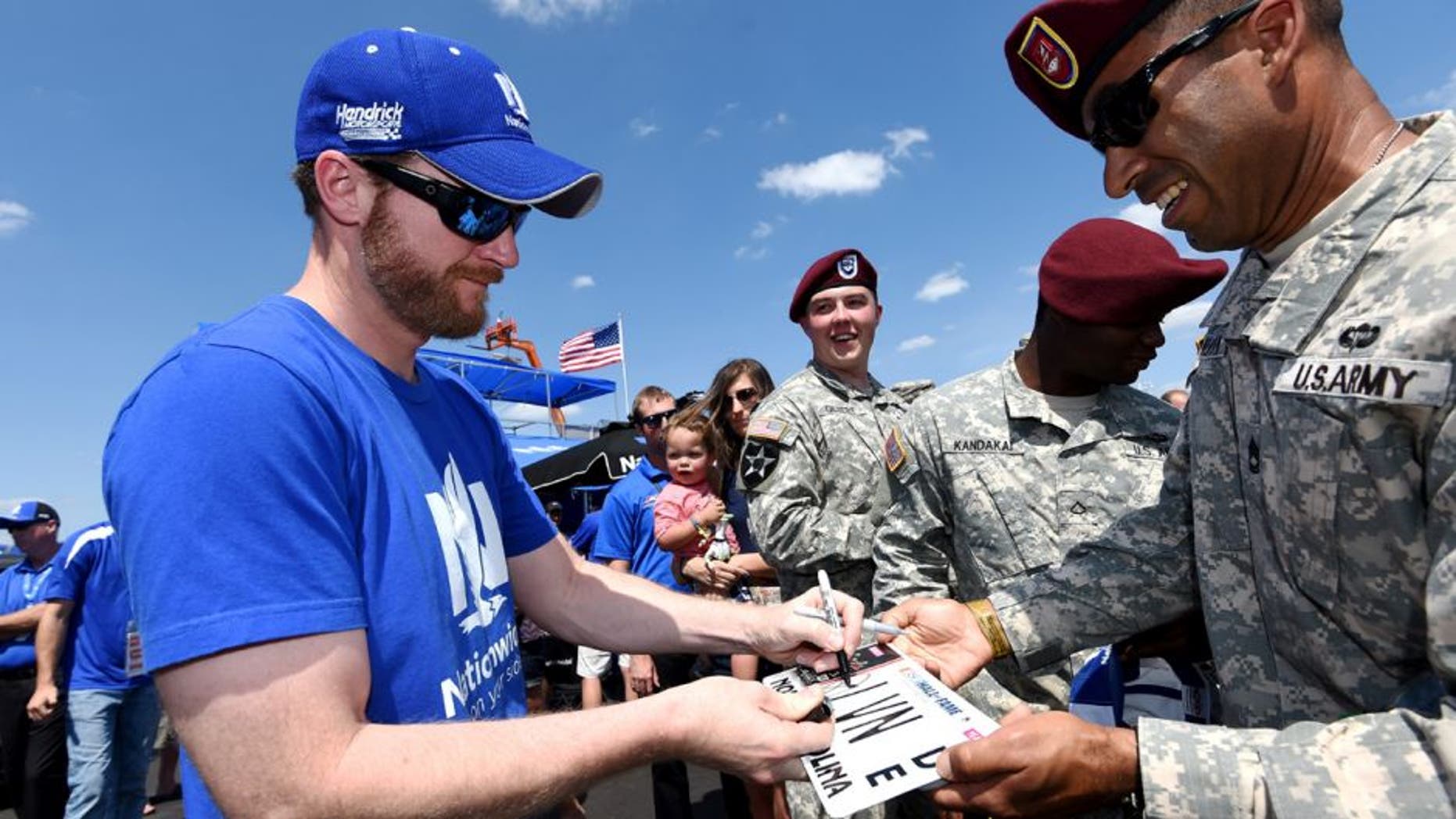 CHARLOTTE, NC - MAY 24: Dale Earnhardt Jr., driver of the #88 Nationwide Chevrolet, signs autographs for U.S. Army members prior to the NASCAR Sprint Cup Series Coca-Cola 600 at Charlotte Motor Speedway on May 24, 2015 in Charlotte, North Carolina. (Photo by Rainier Ehrhardt/Getty Images)