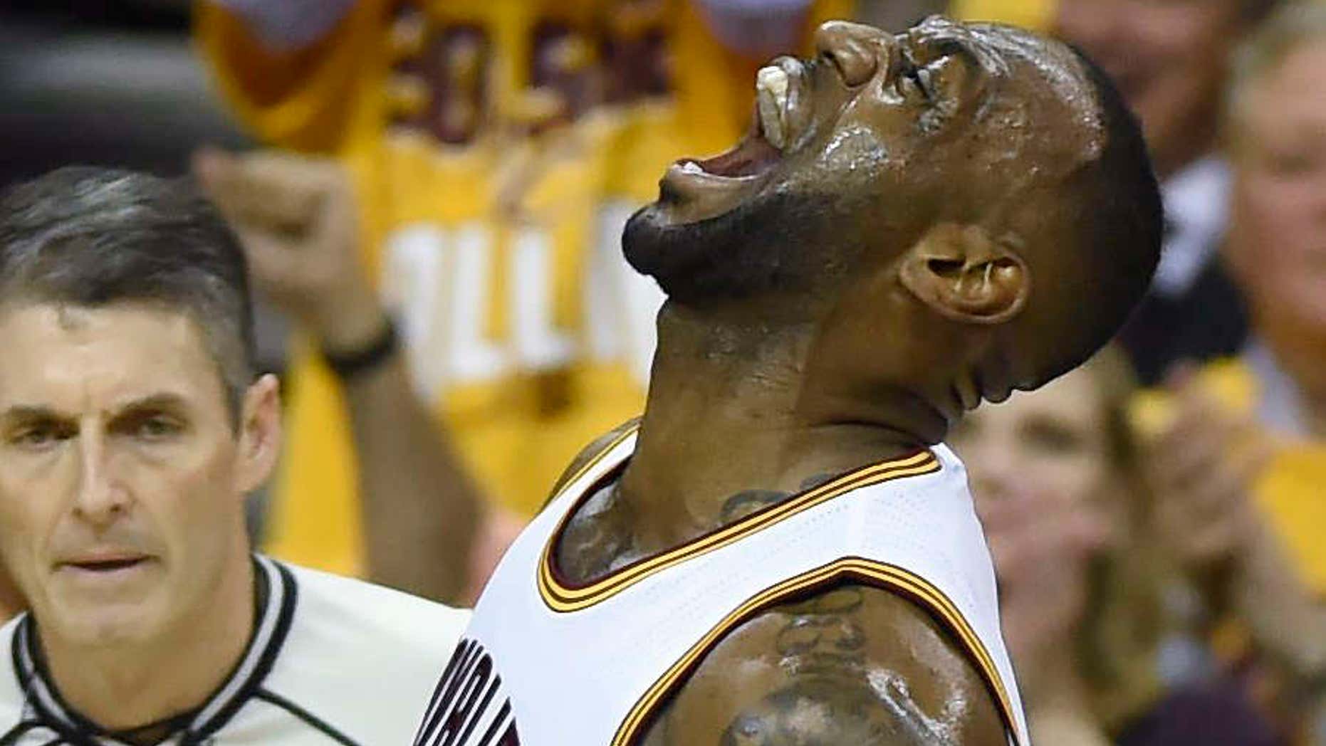 Cleveland Cavaliers' LeBron James (23) celebrates after dunking against the Toronto Raptors during the first half of Game 1 of the NBA basketball Eastern Conference finals Tuesday, May 17, 2016, in Cleveland.