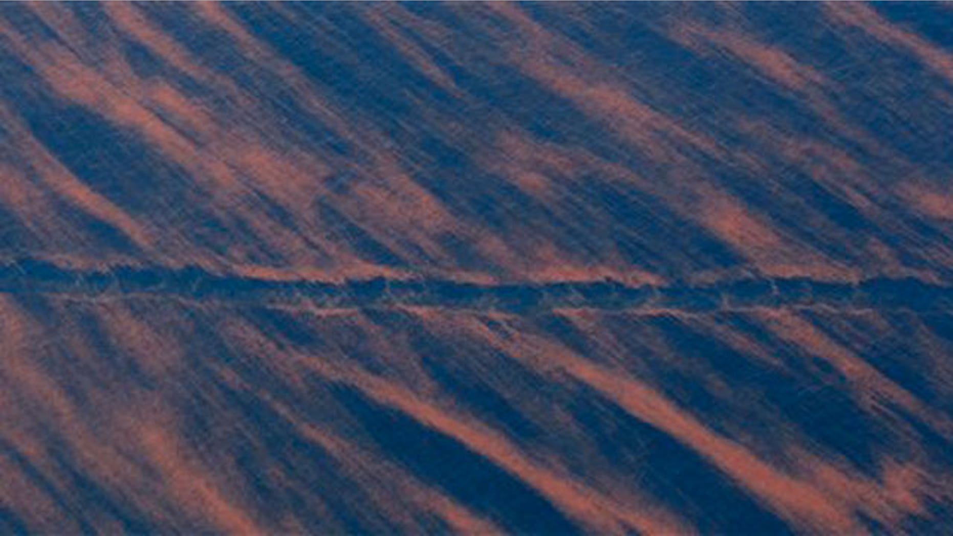 May 17: A ship's wake cuts through a pattern of oil near the site of the Deepwater Horizon oil spill in the Gulf of Mexico.