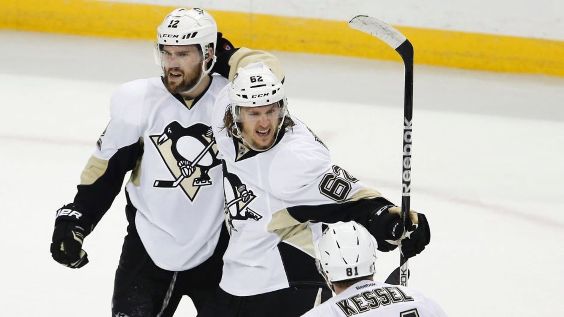 May 18, 2016; Tampa, FL, USA; Pittsburgh Penguins left wing Carl Hagelin (62) celebrates a goal with teammates right wing Phil Kessel (81) and defenseman Ben Lovejoy (12) during the second period in game three of the Eastern Conference Final against the Tampa Bay Lightning of the 2016 Stanley Cup Playoffs at Amalie Arena. Mandatory Credit: Reinhold Matay-USA TODAY Sports