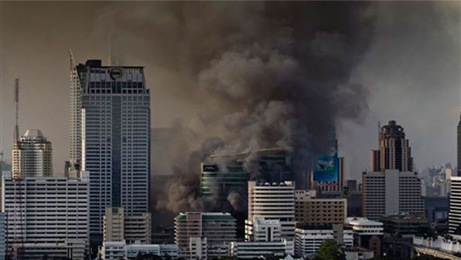 May 19: Smoke rises from burning fires in downtown Bangkok, Thailand, following the surrender of anti-government leaders to the police.