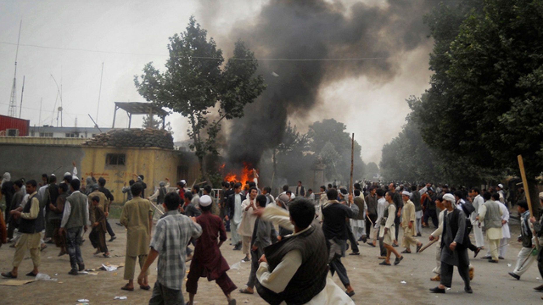 May 19: Smoke rises after protesters set alight police motorcycles at a police headquarter compound during a demonstration in Taloqan, Takhar province, north of Kabul, Afghanistan.