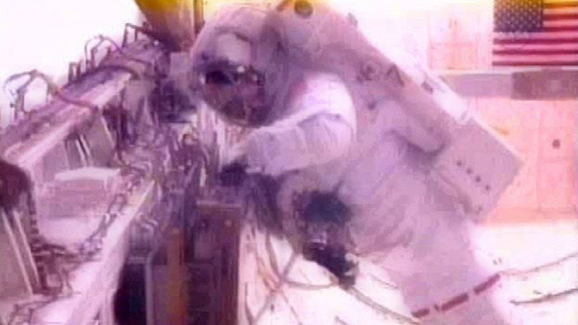 May 20: In a photo made from NASA Television astronaut Greg Chamitoff to stows an experiment shuttle bay of Endeavour.