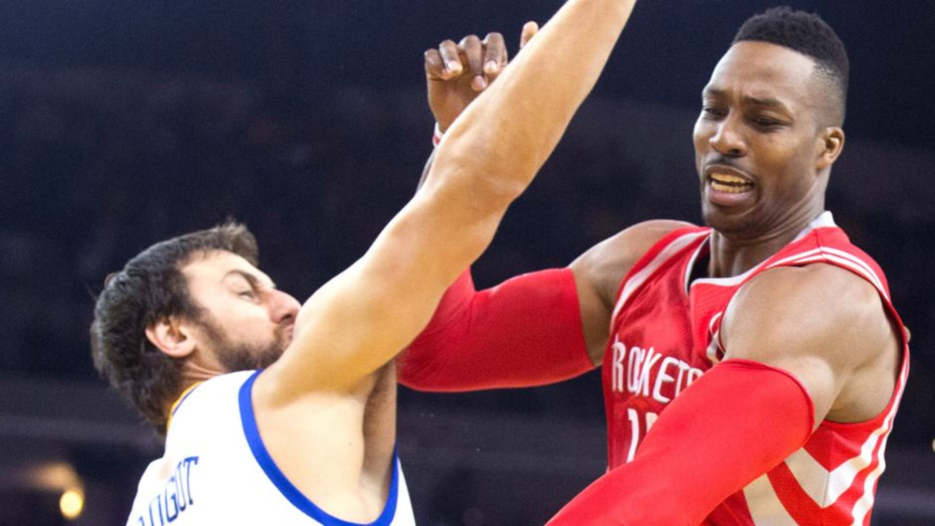 Jan 21, 2015; Oakland, CA, USA; Houston Rockets center Dwight Howard (12) controls the ball against Golden State Warriors center Andrew Bogut (12) during the first quarter at Oracle Arena. Mandatory Credit: Kelley L Cox-USA TODAY Sports