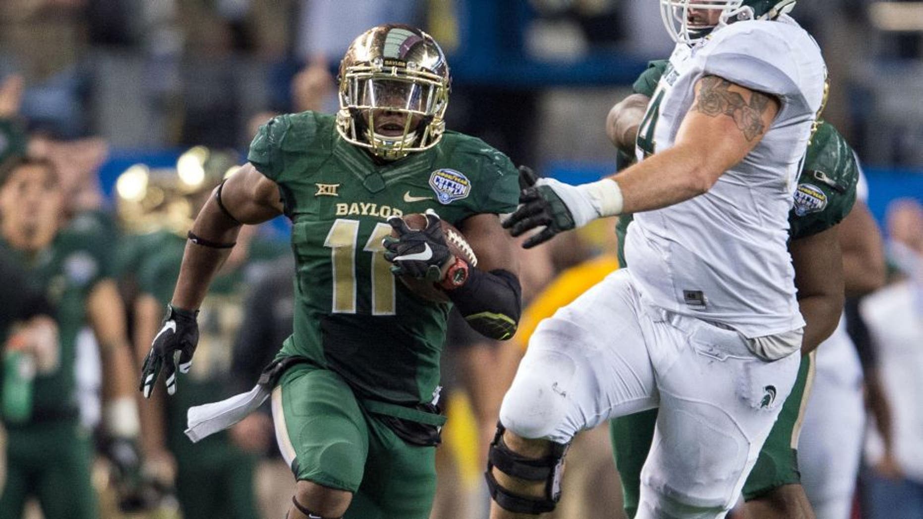 Jan 1, 2015; Arlington, TX, USA; Baylor Bears linebacker Taylor Young (11) returns an interception during the second half against the Michigan State Spartans in the 2015 Cotton Bowl Classic at AT&T Stadium. Young is named the defensive MVP. The Spartans defeated the Bears 42-41. Mandatory Credit: Jerome Miron-USA TODAY Sports
