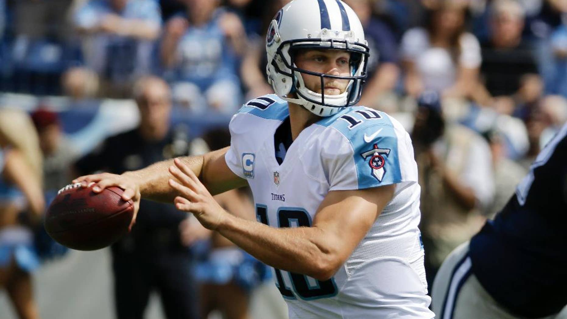 FILE - In this Sept. 14, 2014, file photo, Tennessee Titans quarterback Jake Locker (10) passes against the Dallas Cowboys in the first quarter of an NFL football game in Nashville, Tenn. Locker appears to be ready to return to the starting lineup for Tennessee after missing a game with his injured right wrist. (AP Photo/Wade Payne, File)
