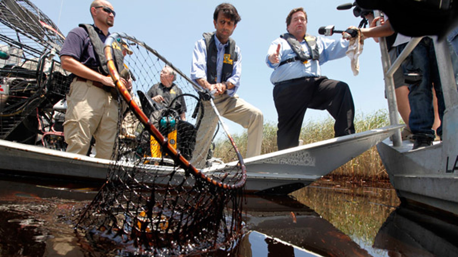 May. 19: Louisiana Gov. Bobby Jindal, center, and Plaquemines Parish President Billy Nungesser, right, tour the oil impacted marsh of Pass a Loutre, La.